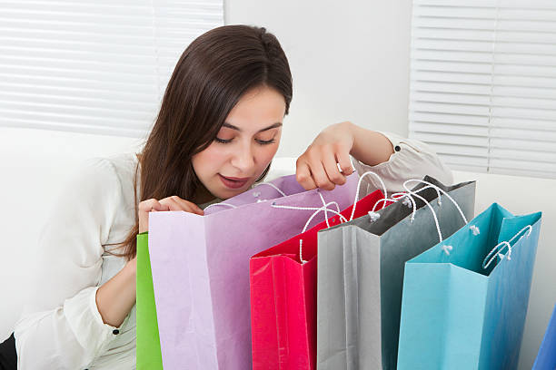 istock Businesswoman Looking Into Shopping Bag 525301585