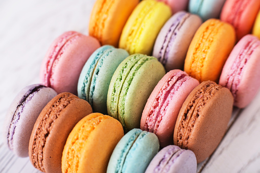 various colour macaroons on wooden table