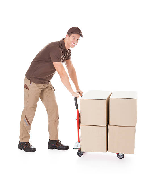 istock Delivery Man Standing Near Boxes And Hand truck 525316445