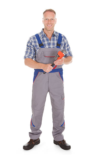 istock Smiling Handyman Holding Adjustable Wrench 525316535