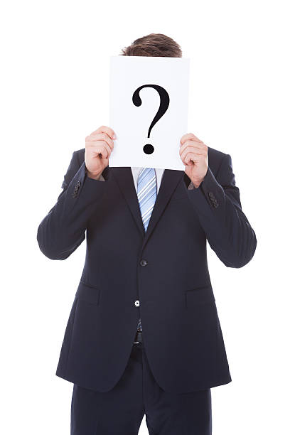 istock Businessman Holding Question Mark Sign In Front Of Face 525317611