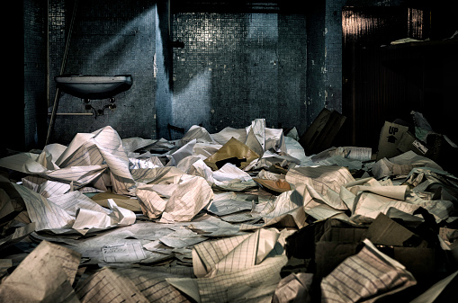 room of an abandoned asylum covered with electroencephalograms paper
