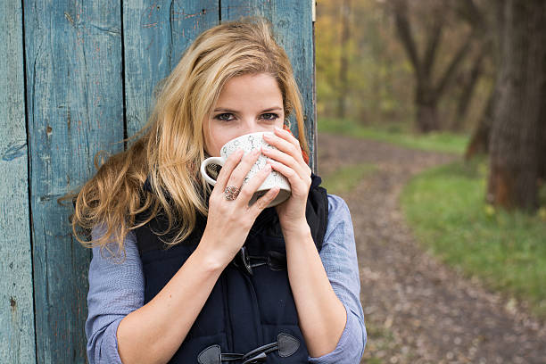 istock Smiling fashionable blonde drinking hot beverage 525317729