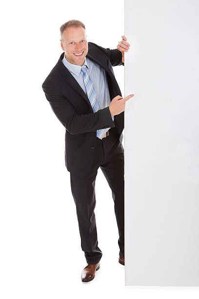 istock Confident Businessman Showing Billboard 525318861
