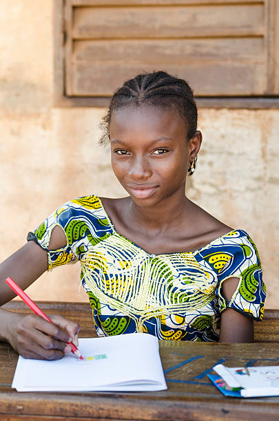 istock African School Girl Writing and Looking at Camera 525318873