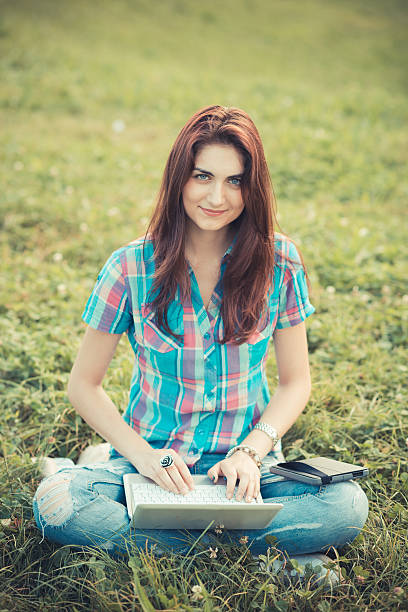 istock beautiful young hipster woman using laptop and tablet 525319409