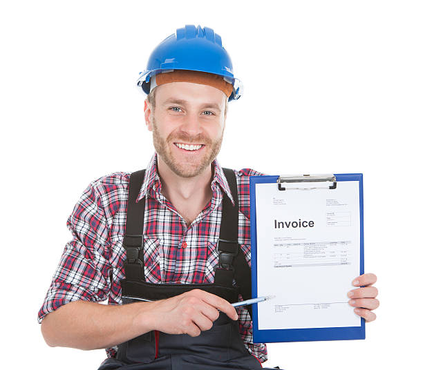 istock Handyman Showing Invoice On Clipboard 525319713
