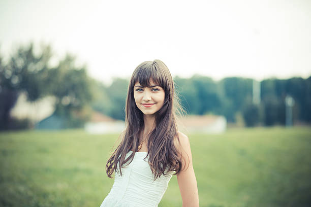 beautiful young woman with white dress in the city