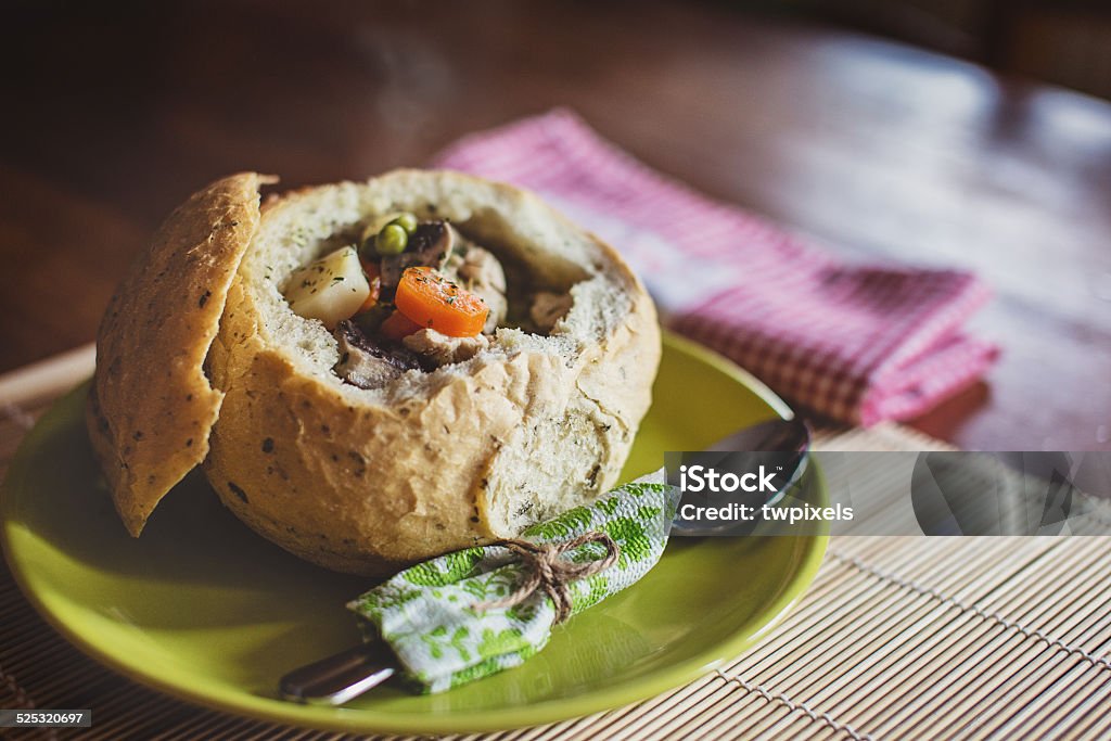 Stew Soup in Bread Loaf Stew Soup - Tarragon Turkey with vegetables served in Bread Loaf. Back Lit Stock Photo