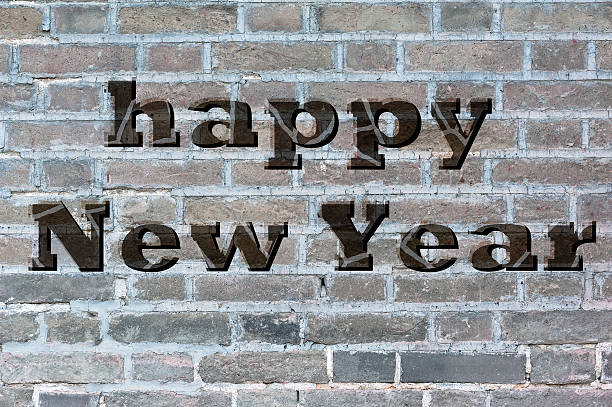 istock Happy New Year on the grey brick wall 525323723