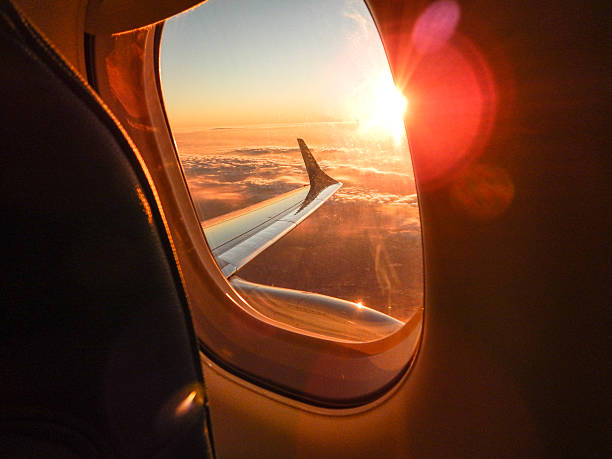 Sunlight from the porthole on airplane stock photo