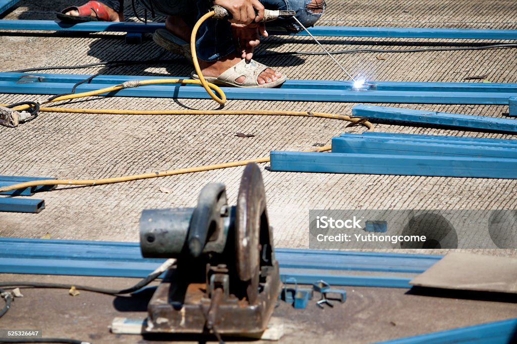 Welder and cutting metal with grinder Adult Stock Photo