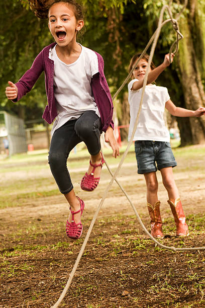 istock Little Girls Skipping Rope in Park 525326729