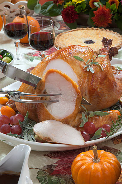 Carving Roasted Turkey on Harvest Table stock photo