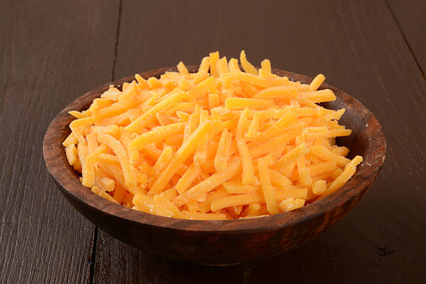 istock Bowl of grated cheddar cheese 525328571