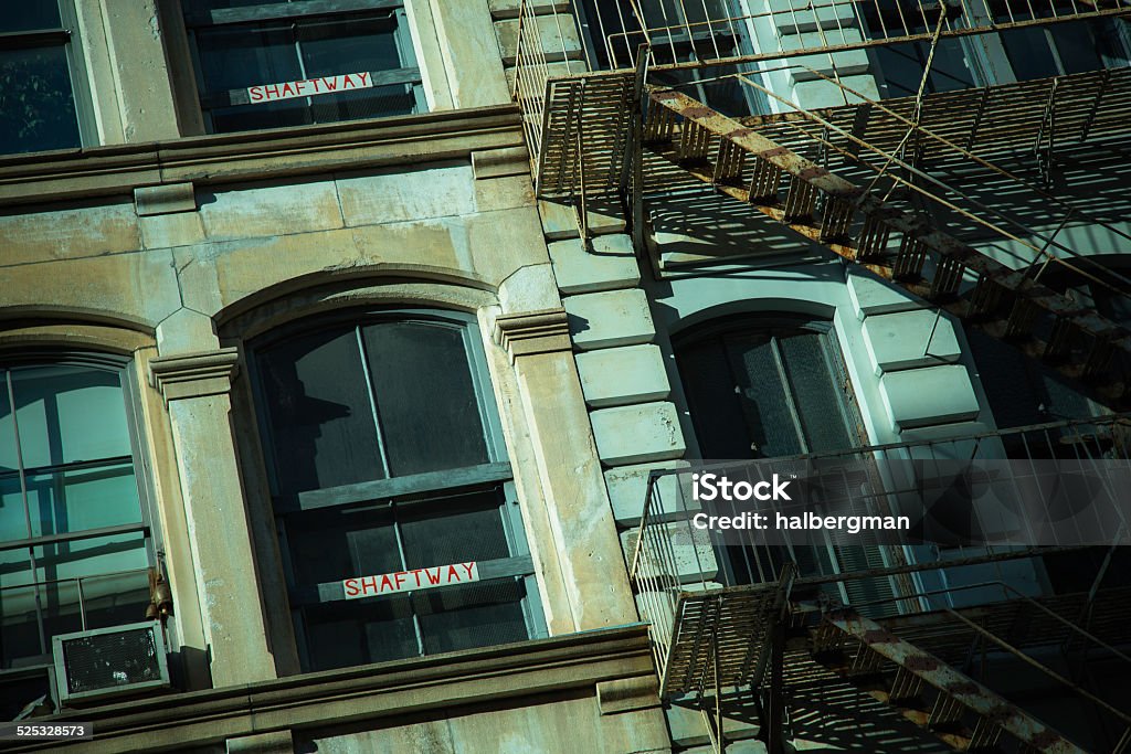 Manhattan Building Shaft Way Architectural detail of a Manhattan building, showing windows, an exterior fire escape and a window air conditioning unit. One of the windows is blocked out, with the word "SHAFT WAY" printed on it. Air Conditioner Stock Photo