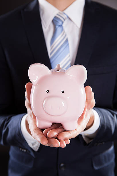 istock Businessman Holding Piggybank 525328821