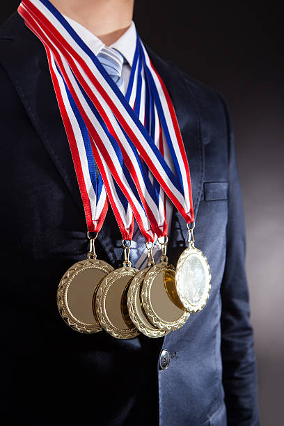 istock Businessman Wearing Gold Medals 525329211