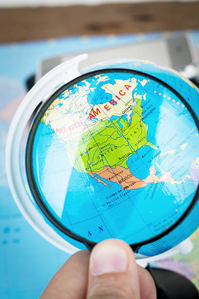 istock Image of magnifier grass on world map. 525329729