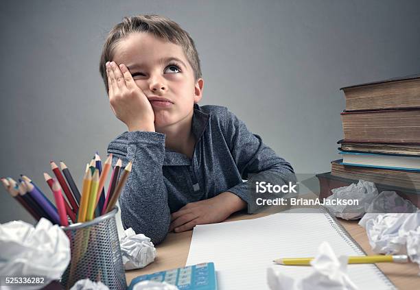 Bored And Fed Boy Up Doing His Homework Stock Photo - Download Image Now - Child, Boredom, Writing - Activity