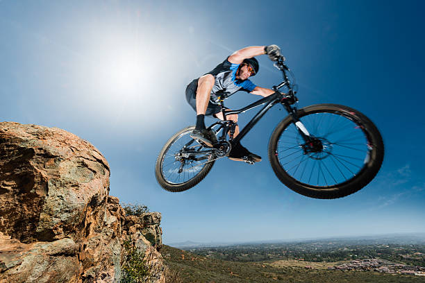 istock Extreme Mountain Biker Jumping Off A Cliff 525337414