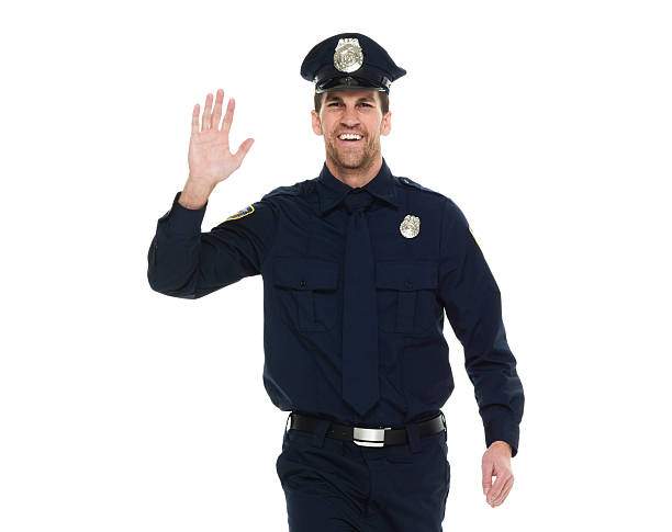 istock Cheerful police waving hand 525338124