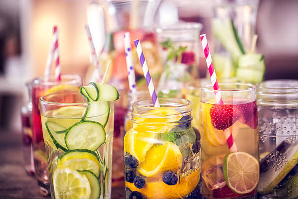 Variation of Infused Water with Fresh Fruits Variation of Infused water with fresh fruits like raspberries, lemon, pomegranate,berries, oranges, lime and mint. cold drink stock pictures, royalty-free photos & images