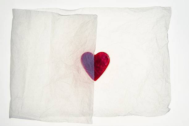 istock Heart shaped partially covered by packaging tissue paper 525338560