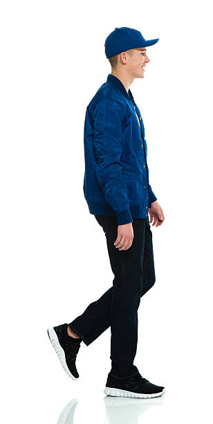 istock Smiling male walking and looking away 525339024