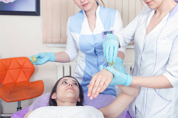istock Beautiful woman in spa salon receiving epilation or correction e 525339428