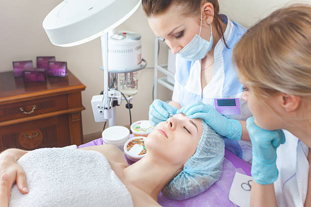 istock Beautiful woman in spa salon receiving epilation or correction e 525339964