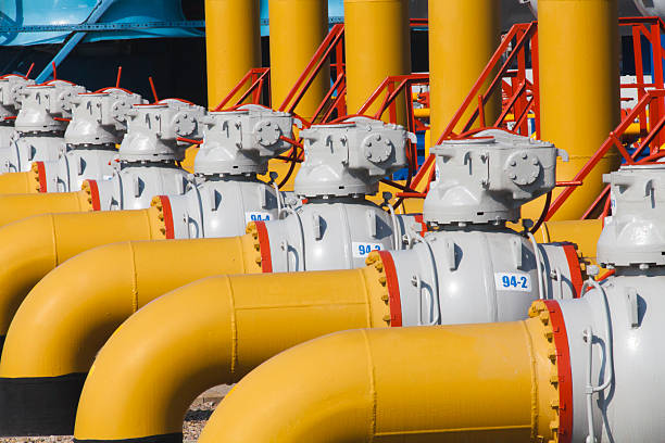 Pipes and valves are on the gas compressor station Pipes and valves with handles are on the gas compressor station. gas compressor stock pictures, royalty-free photos & images