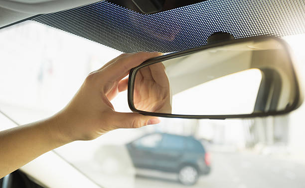 istock Closeup of driver adjusting rear view mirror 525341336