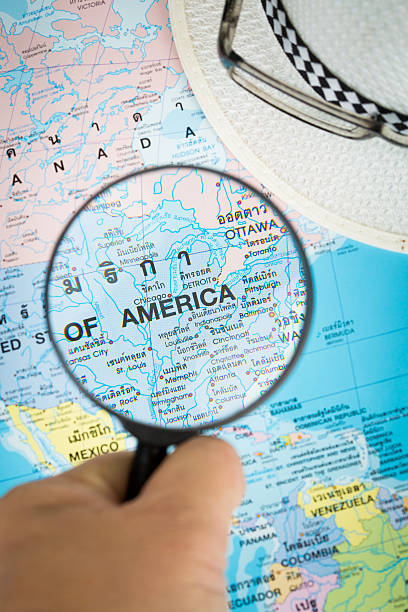 istock Image of magnifier grass on world map. 525341357