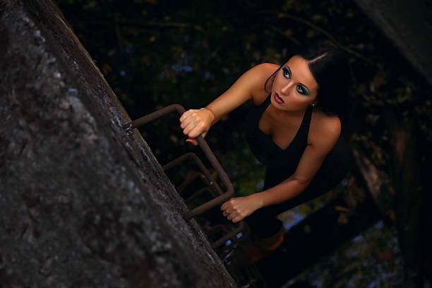 istock Thief woman climbing ladder from underground tunnel 525341981