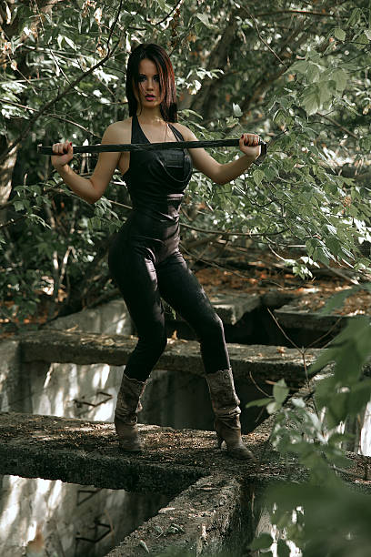 istock Warrior woman standing on the ruins in the forest 525341995