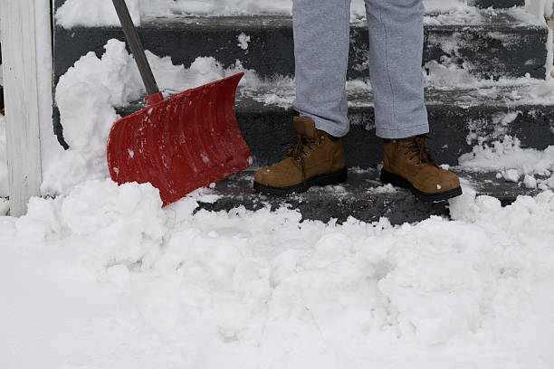 istock Snow being shoveled by a man in boots 525342178