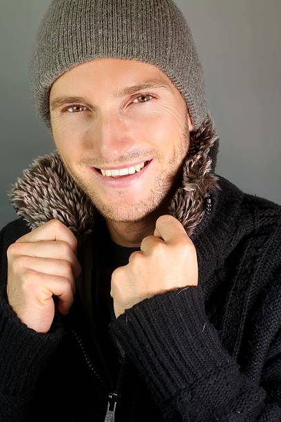 cute smiling man with hat on a grey background