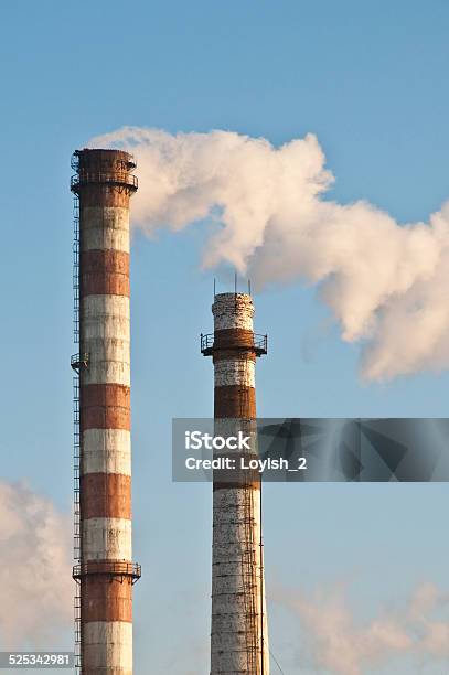 Two Pipes And Smoke Stock Photo - Download Image Now - Blue, Chimney, Cloud - Sky