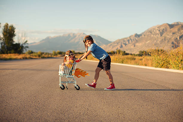 istock Two Young Boys Racing Shopping Cart 525343892