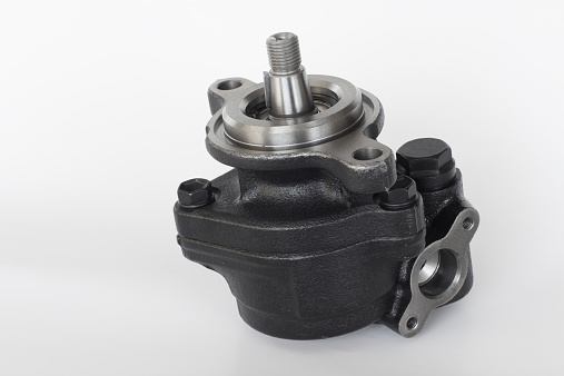 power steering pump on a gray background. engine parts