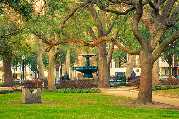 Bienville Square and Park in Downtown Mobile Alabama USA Photo of Bienville Square, a historic city park with an old ornate fountain in downtown Mobile, Alabama, USA alabama stock pictures, royalty-free photos & images