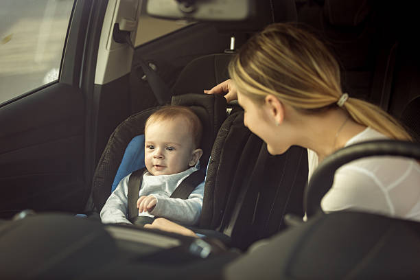 istock Mother and baby sitting in car on front seats 525346280
