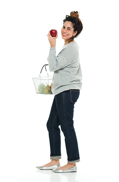 istock Cheerful woman holding fruit basket 525346302