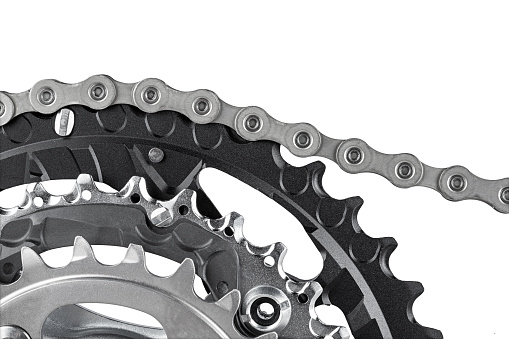 close-up of bicycle crank set with chain isolated on white background