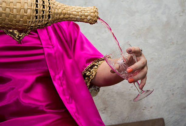 Pouring wine by girle's hands