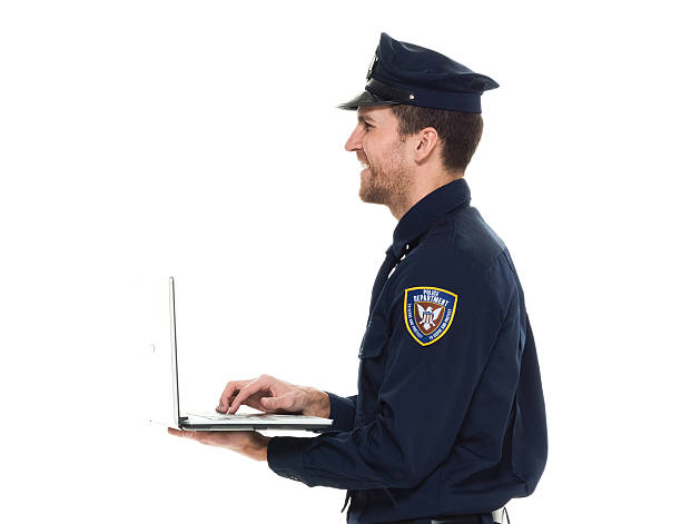 istock Smiling police working on laptop 525350298
