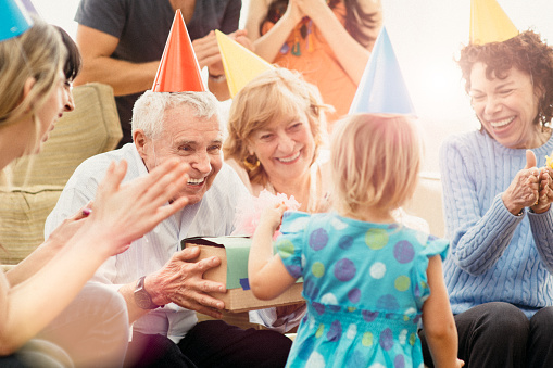 Multigenerational family celebrating great grandfather's birthday