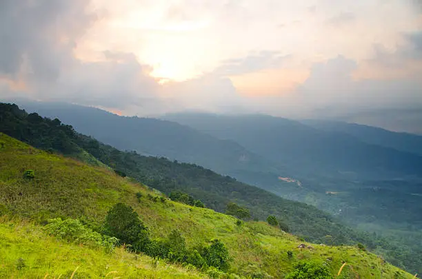 majestic sunrise clouds and path through a mountain meadow to horizon