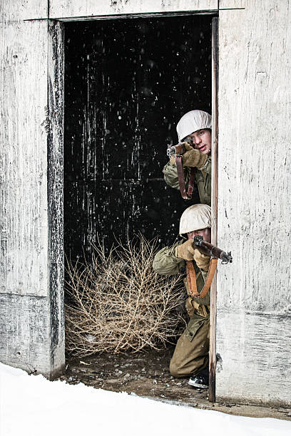 istock Young WWII US Infantry Soldiers Shooting From A Bunker 525351820